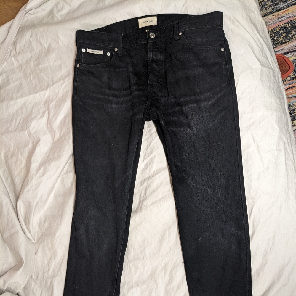 Fear of God (FOG) Essentials Slim Fit Cone Denim Jeans in color Black